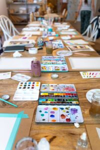 Watercolour palettes and art supplies set up for a creative wellness workshop in Victoria, BC